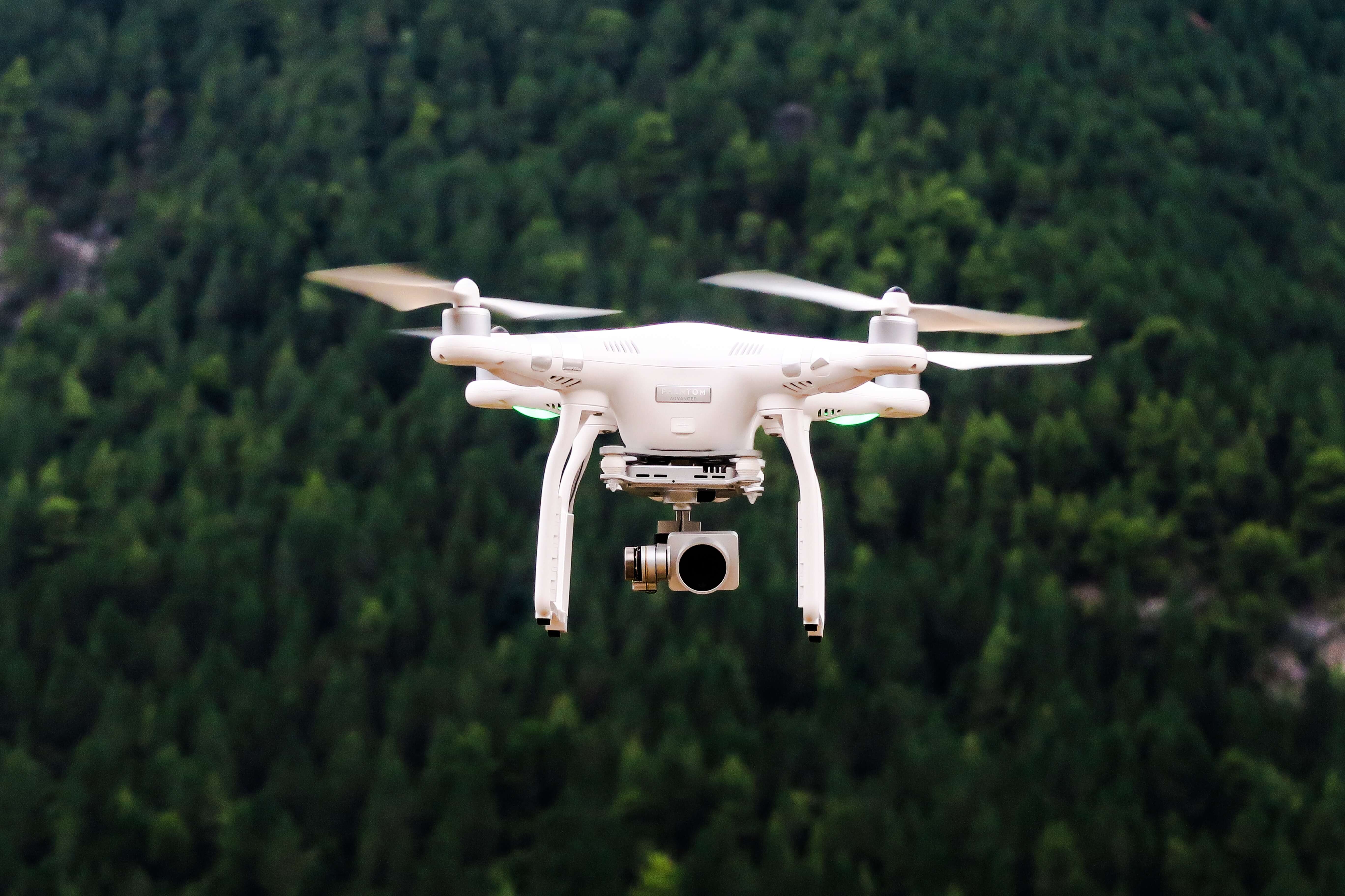 a drone flying over the forest