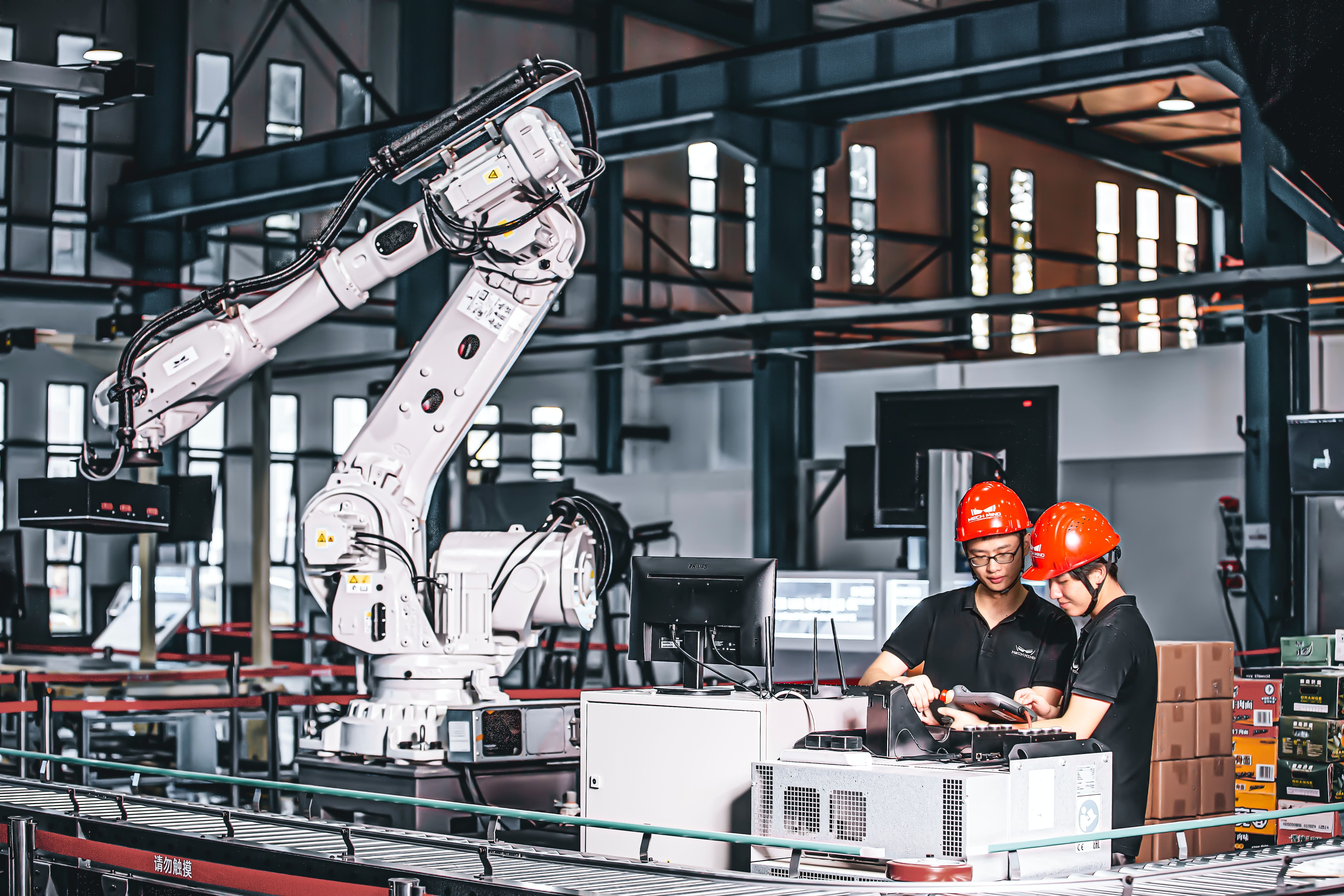 workers and automated manufacturing assembly